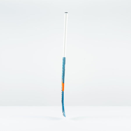 The Grays JB 7+ Junior Hockey Stick 2026, in blue and white, featuring advanced Graphene for improved drag-flicking control, stands upright on a plain white surface against a light gray background.