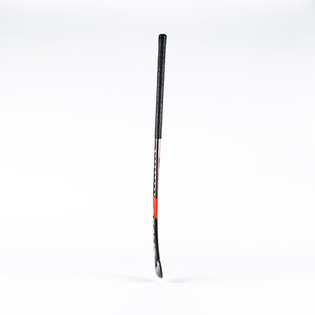 A Grays DB6 Junior Hockey Stick by Grays, featuring a black grip, red and black shaft, and curved blade, stands upright against a plain white background.