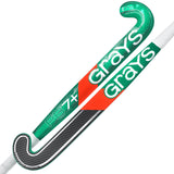 The Grays PB 7+ Senior Hockey Stick 2026 features a green and white design, bold Grays branding, black and carbon fiber head details, a red diagonal stripe on one stick, and is made for intermediate power.
