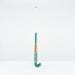 A green and white Grays PB 7+ Junior Hockey Stick 2026 with orange accents stands upright against a plain white background, displaying the brand name and offering intermediate power plus supreme control.