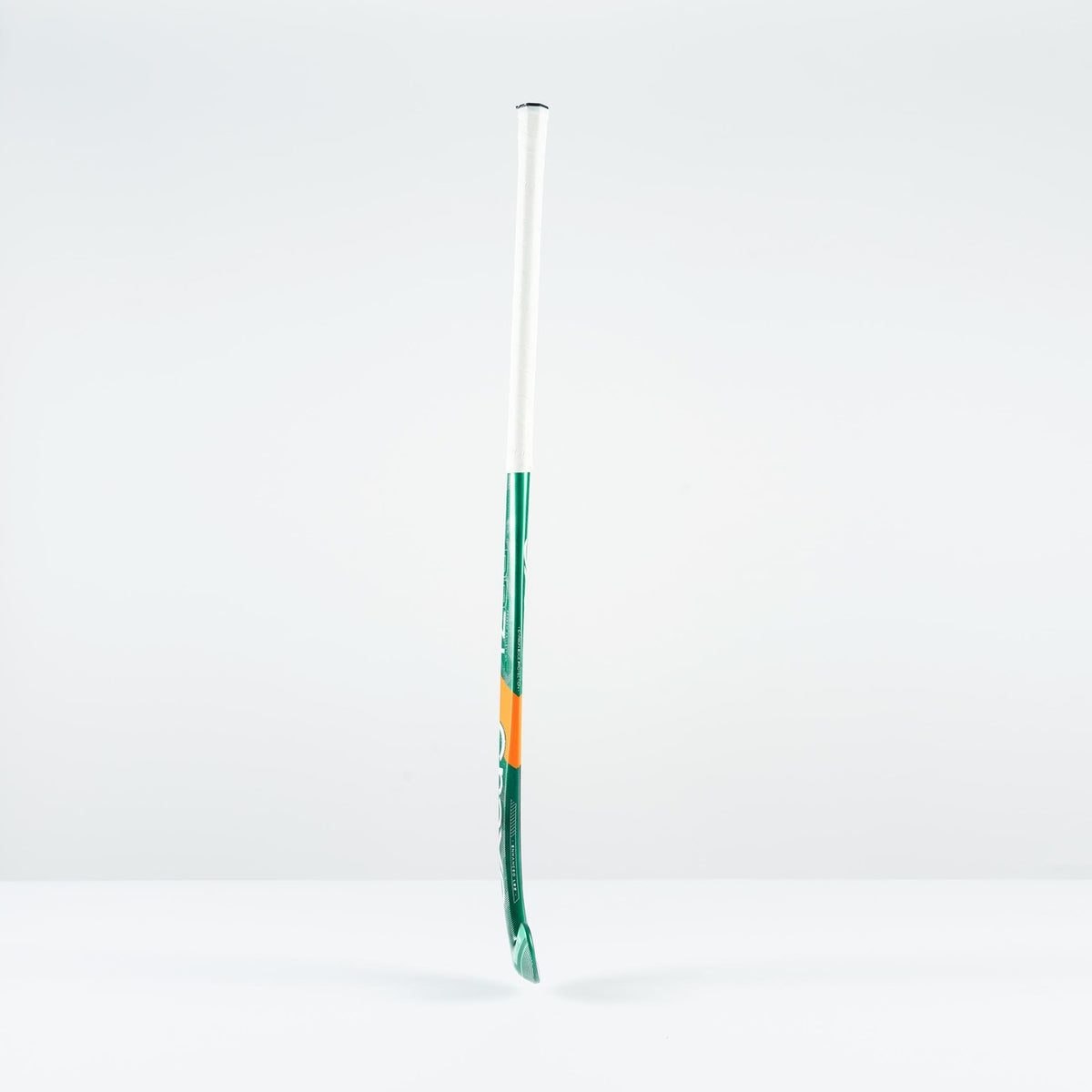 The Grays PB 7+ Junior Hockey Stick 2026, featuring green, white, and orange accents, stands upright against a plain white background, offering supreme control and intermediate power.