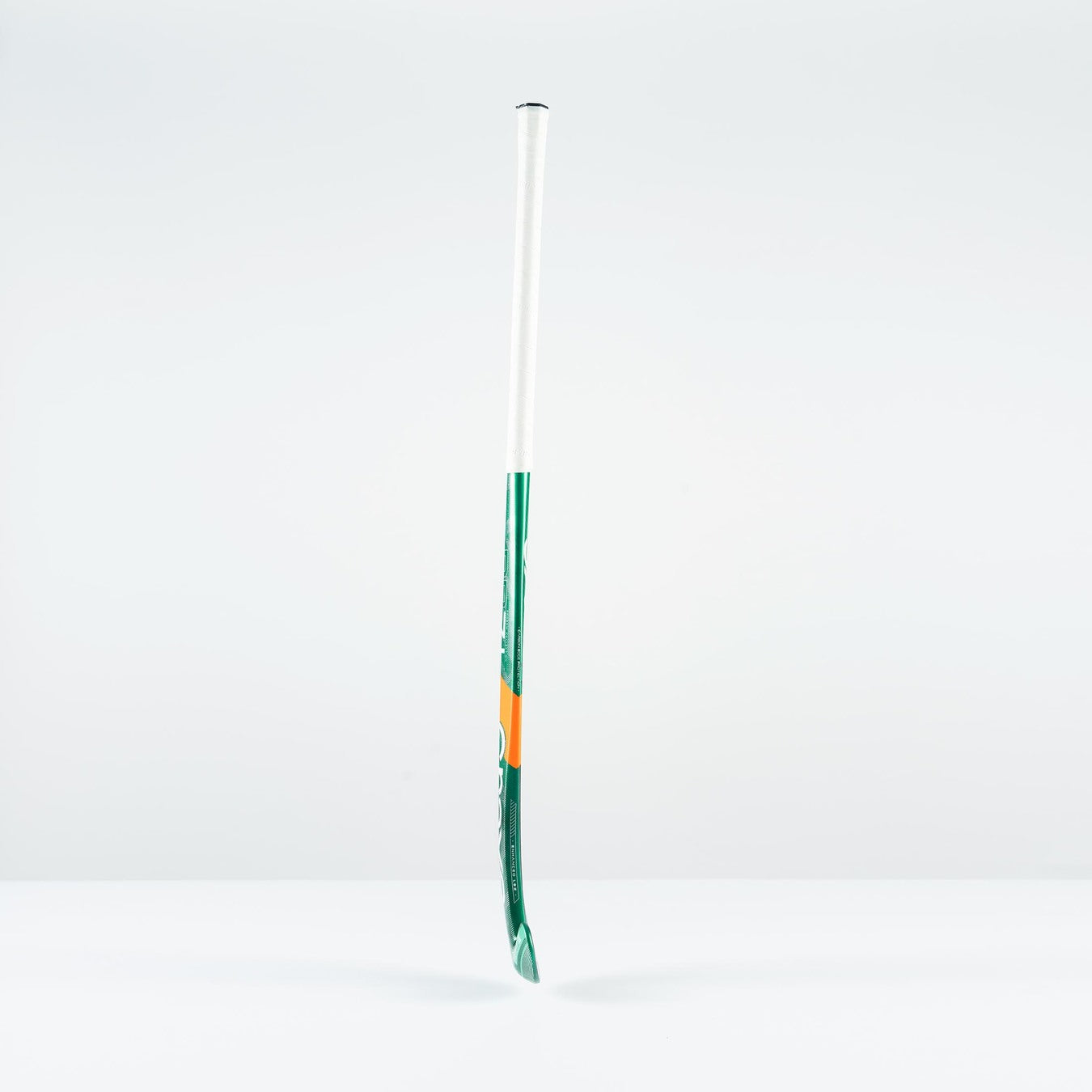 The Grays PB 7+ Junior Hockey Stick 2026, featuring green, white, and orange accents, stands upright against a plain white background, offering supreme control and intermediate power.