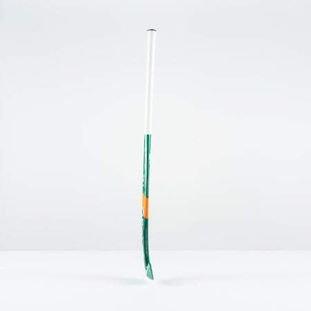 The Grays PB 7+ Junior Hockey Stick 2026, featuring green, white, and orange accents, stands upright against a plain white background, offering supreme control and intermediate power.
