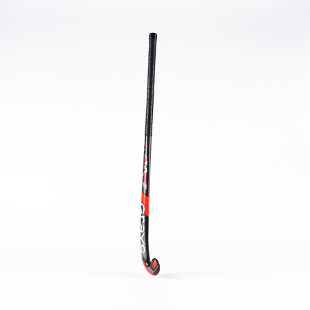 The Grays Jumbow 6 Senior Hockey Stick by Grays, featuring a black and red design with a Jumbow blade profile and curved end, stands upright against a plain white background.