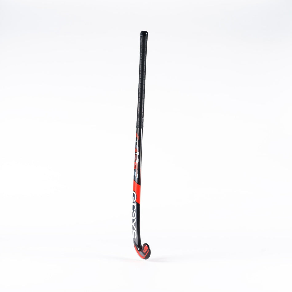 The Grays Jumbow 6 Senior Hockey Stick by Grays, featuring a black and red design with a Jumbow blade profile and curved end, stands upright against a plain white background.