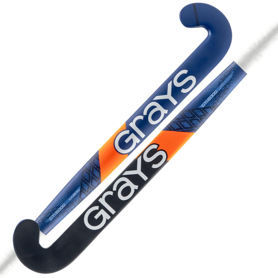 Two Grays GTI6000 Jumbow indoor hockey sticks: one mainly navy with a black head and low bow, ideal for drag flicking; the other in blue and orange. Both display white Grays logos.
