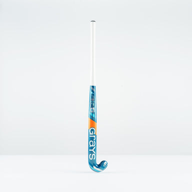 The Grays JB 6 Junior Hockey Stick 2026, in blue, white, and orange, designed for drag-flicking, stands upright against a plain white background.