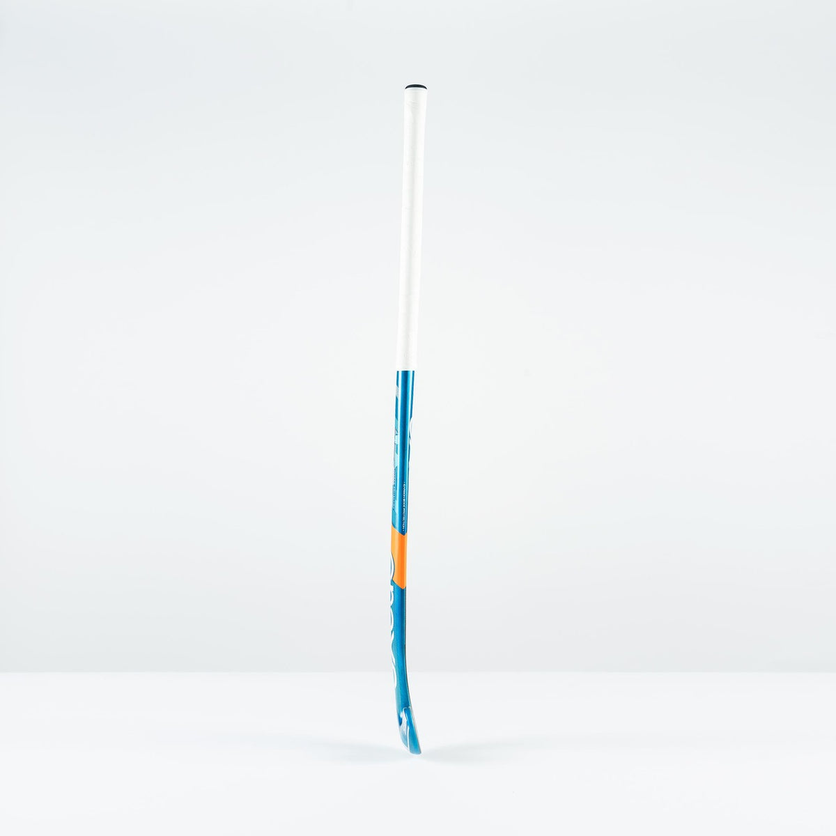The Grays JB 6 Senior Hockey Stick 2026 stands upright on a white surface with a light gray background—perfect for players honing their drag-flicking skills.