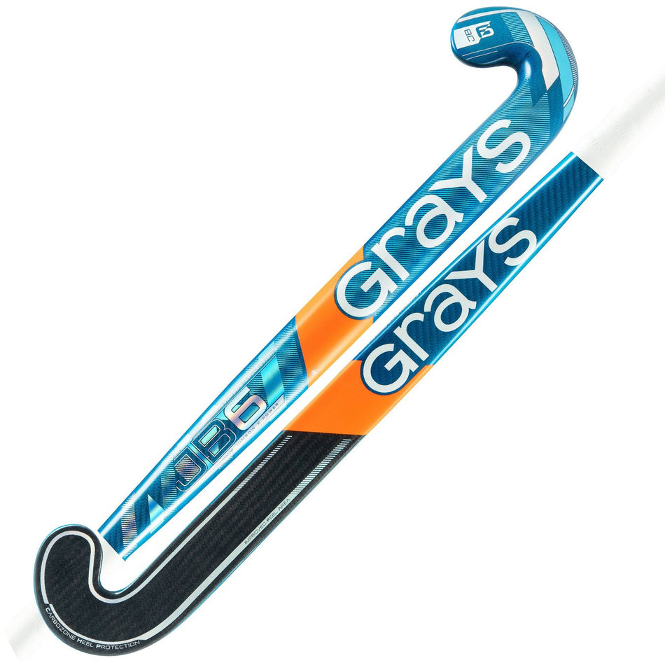 Two blue, orange, and black Grays JB 6 Senior Hockey Stick 2026 feature a curved hook for powerful drag-flicking. The large white Grays brand name is prominent along the shaft.