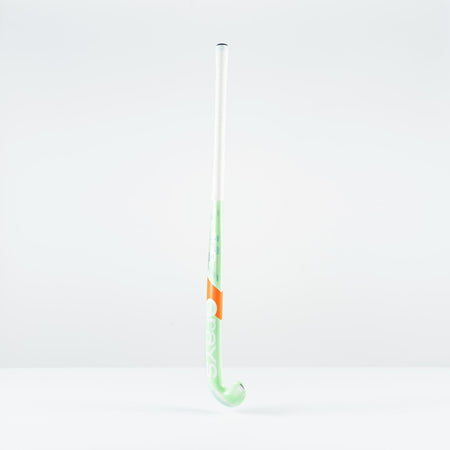 The Grays JB 5 Junior Hockey Stick 2026, featuring green and white colors with an orange band and a Jumbow blade for drag-flicking, stands upright against a plain white background.