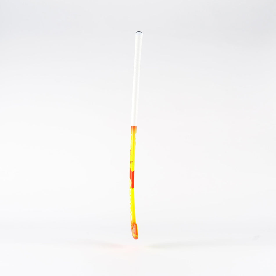 The Grays UB5 Junior Hockey Stick by Grays, shown upright against a white background, features a yellow and orange design with a white grip and an Ultrabow blade for intermediate power.