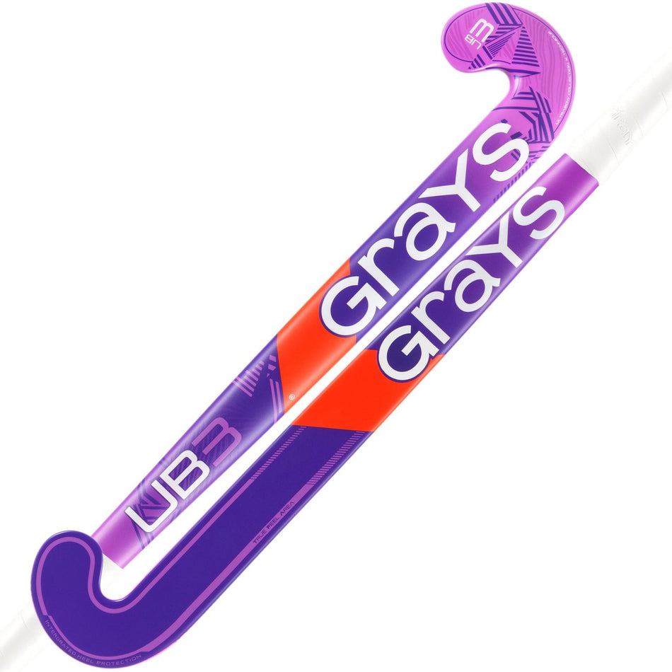Two purple Grays UB3 Junior Hockey Sticks are crossed, each branded with "Grays" in bold white letters. Both feature an Ultrabow blade for enhanced ball control, with one showcasing a red accent and the other a patterned head design.