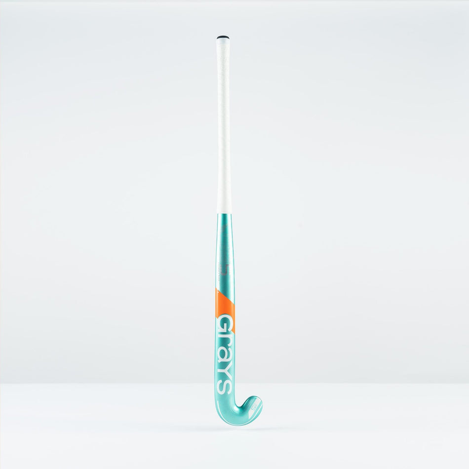 The Grays DB 5 Junior Hockey Stick 2026, in teal and white with orange accents and a Dynabow blade, stands upright on a white surface against a plain white background.