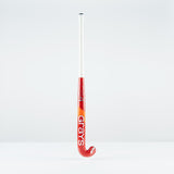 The Grays DB 4 Junior Hockey Stick 2026 features a red and orange design, Dynabow blade profile, white grip, and large Grays branding—standing upright on a plain white background for enhanced 3D skill execution.