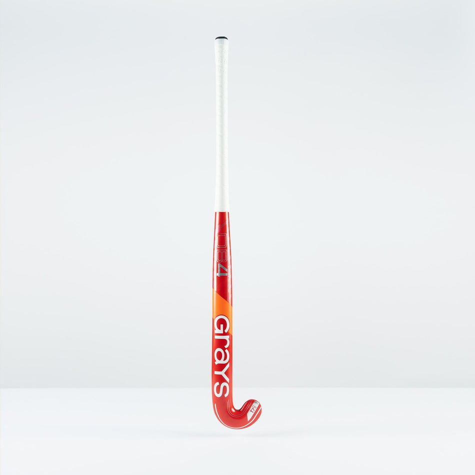 The Grays DB 4 Junior Hockey Stick 2026 features a red and orange design, Dynabow blade profile, white grip, and large Grays branding—standing upright on a plain white background for enhanced 3D skill execution.