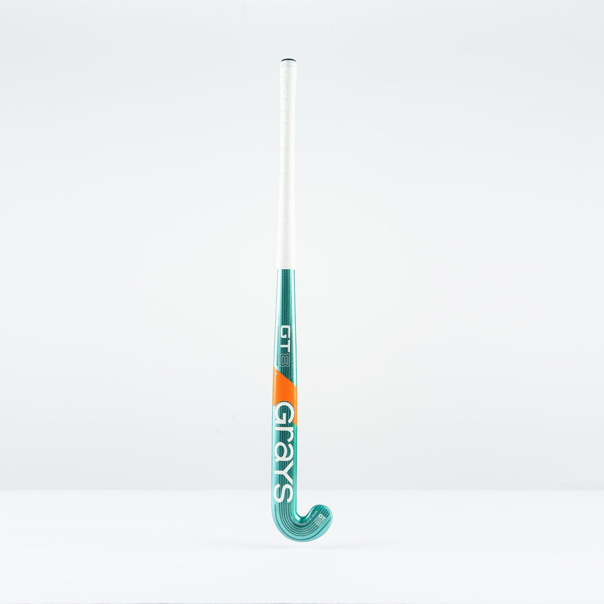 The Grays GT 8 Senior Hockey Stick 2026 stands upright against a white background, featuring teal and white colors with orange accents and aluminised-carbon construction. The brand name Grays is written vertically on the stick.