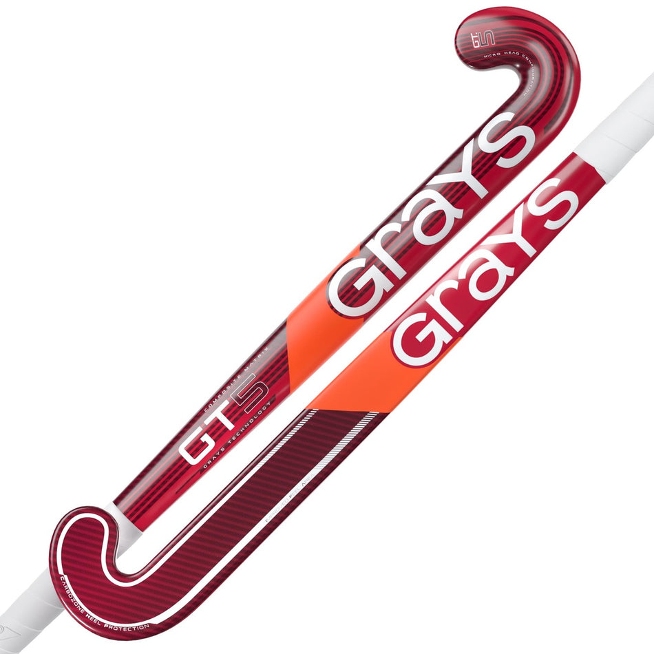 Two Grays GT 5 Senior Hockey Sticks 2026 are shown diagonally, highlighting the red and orange design, bold white Grays branding, aluminised-carbon build, high bow apex, and white handle grips.