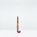 The Grays GT 5 Junior Hockey Stick 2026, featuring a red and white design with a high bow apex and bold Grays branding, stands upright against a plain white background.