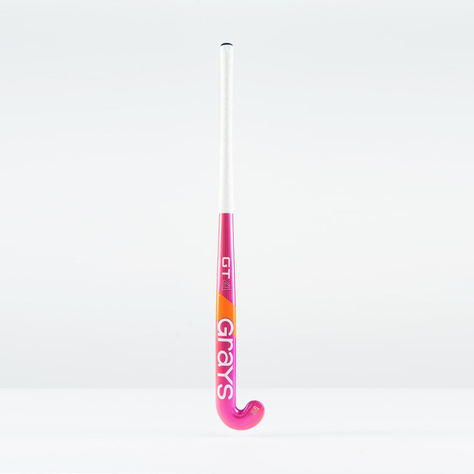 The Grays GT 4 Junior Hockey Stick 2026, featuring a hot red design and the Grays logo, stands upright against a plain white background.