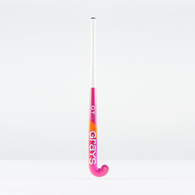 The Grays GT 4 Junior Hockey Stick 2026, featuring a hot red design and the Grays logo, stands upright against a plain white background.