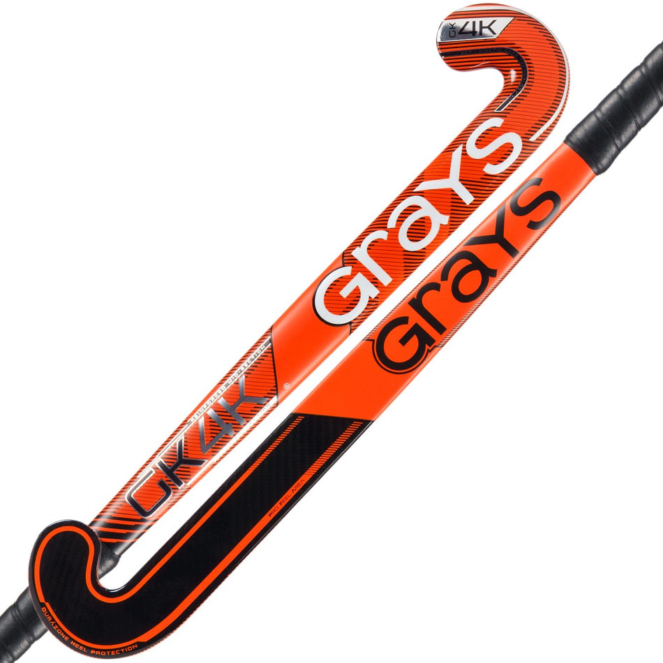 Two Grays GK4K Elite Hockey Sticks in orange and black, featuring curved heads, textured grips, and a reinforced mid-section for enhanced durability and field performance.