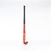 The Grays GK4K Elite Hockey Stick, a red stick with a black grip handle and reinforced mid-section, stands upright against a plain white background.