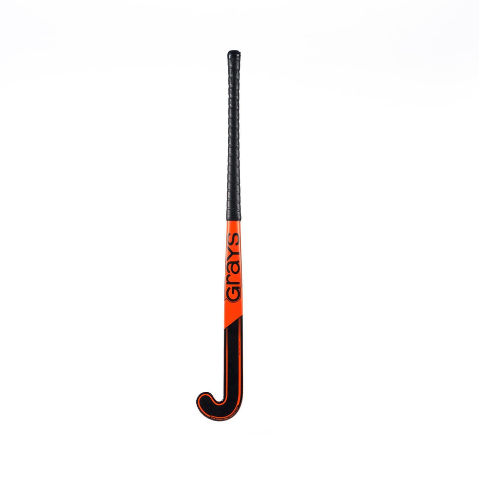 The Grays GK4K Elite Hockey Stick features a black handle, orange and black shaft, and the Grays brand name in black. Its reinforced mid-section ensures added durability. Displayed against a plain white background.