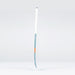 The Grays JB6Xi Jumbow Indoor Senior Hockey Stick 2026, featuring a white handle, blue shaft, and orange accent with a Jumbow blade, stands upright against a plain light gray background.