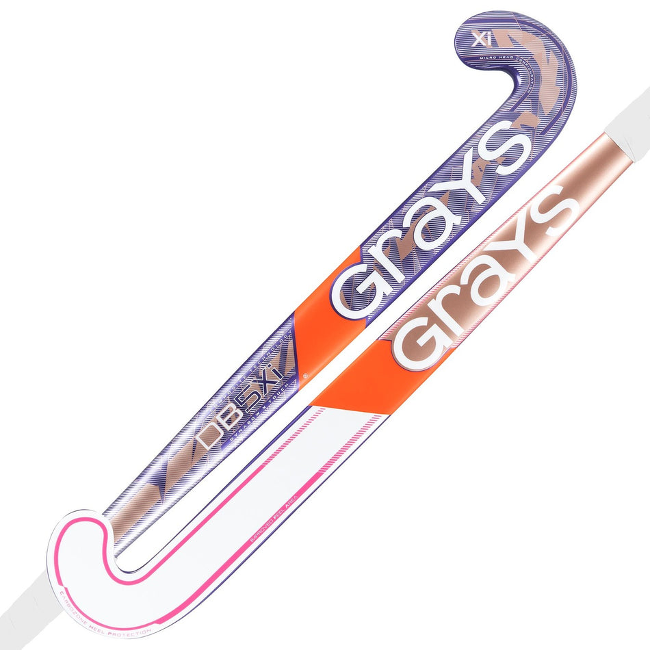Two Grays field hockey sticks are crossed: a purple and orange DB5Xi Dynabow Indoor Senior Hockey Stick 2026, and a metallic bronze and white stick with pink. Both feature curved blades and modern designs.