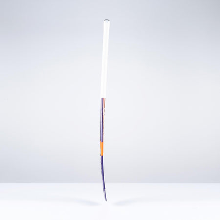 A Grays DB5Xi Dynabow Indoor Senior Hockey Stick 2026 stands upright on a white surface against a light gray background, its shaft visibly bent and lower frame damaged, resembling a well-used stick after intense all-round play.