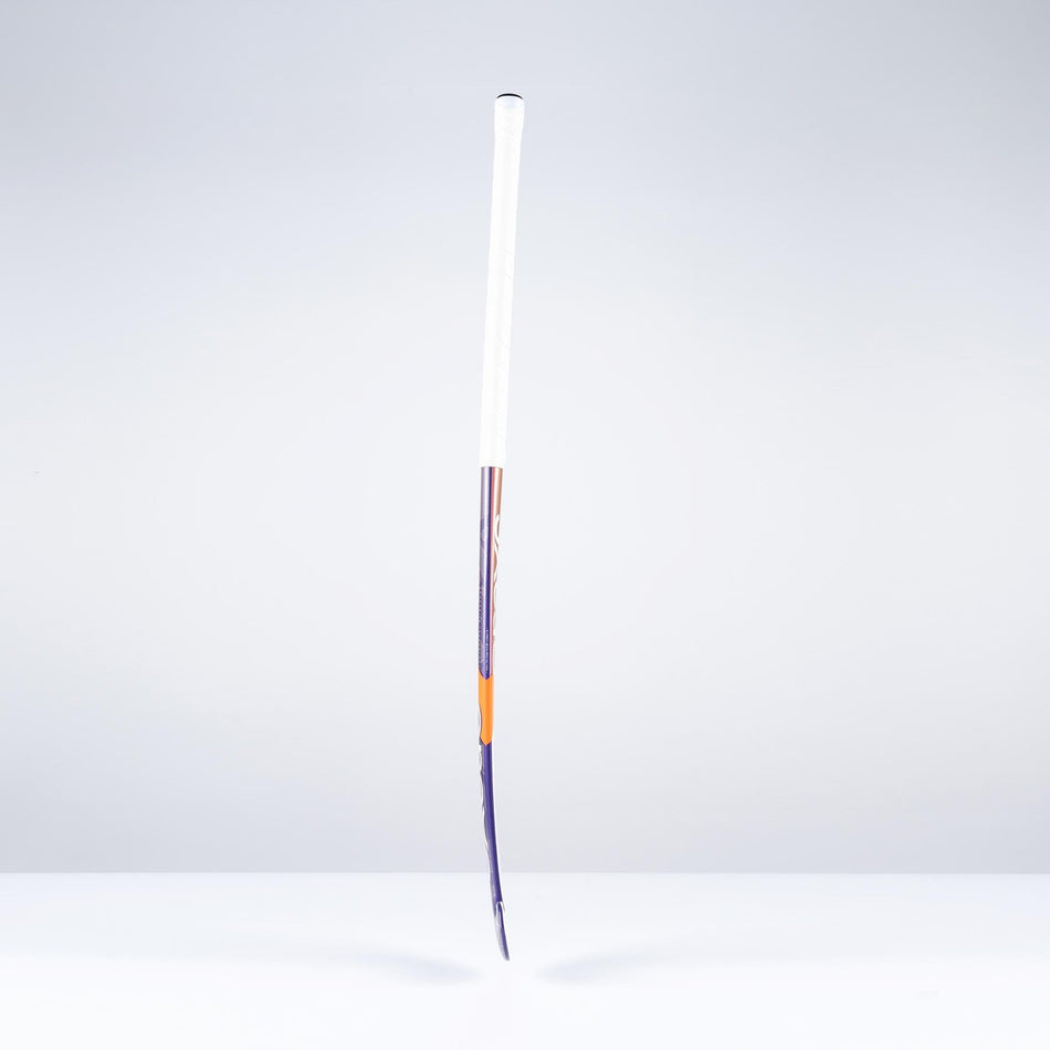 A Grays DB5Xi Dynabow Indoor Senior Hockey Stick 2026 stands upright on a white surface against a light gray background, its shaft visibly bent and lower frame damaged, resembling a well-used stick after intense all-round play.