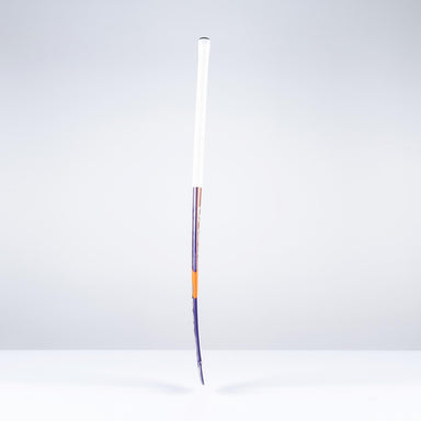 A Grays DB5Xi Dynabow Indoor Senior Hockey Stick 2026 stands upright on a white surface against a light gray background, its shaft visibly bent and lower frame damaged, resembling a well-used stick after intense all-round play.