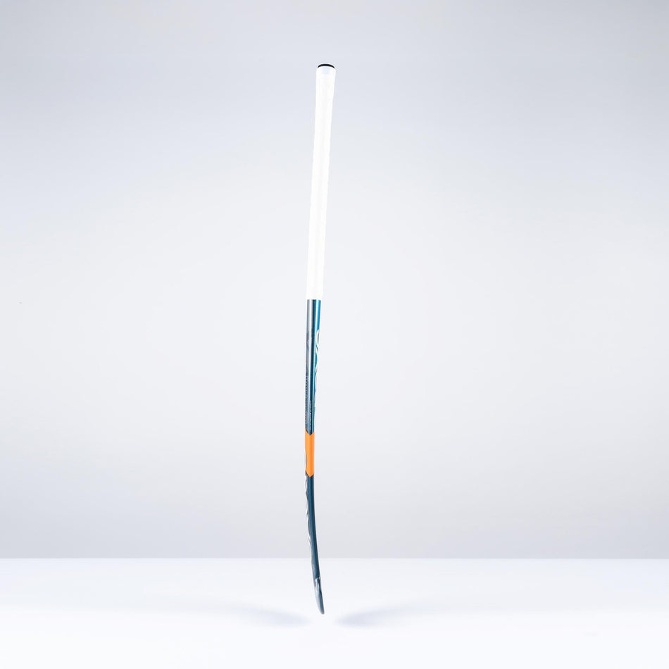 The Grays DB4Xi Dynabow Indoor Senior Hockey Stick 2026 stands upright against a white background, featuring a white grip, blue shaft, and orange accent—its sleek form highlighting the quality craftsmanship from Grays.