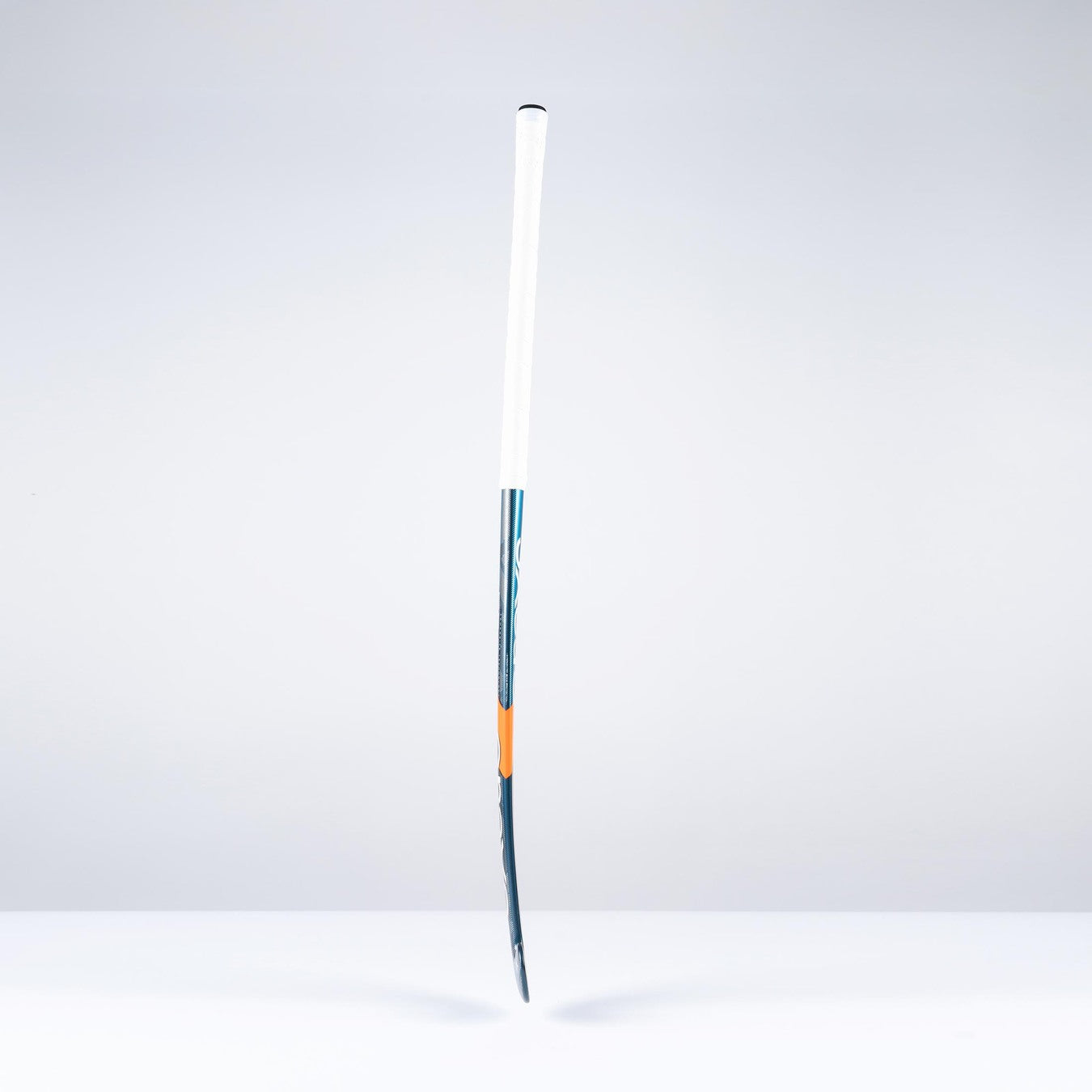 The Grays DB4Xi Dynabow Indoor Senior Hockey Stick 2026 stands upright against a white background, featuring a white grip, blue shaft, and orange accent—its sleek form highlighting the quality craftsmanship from Grays.