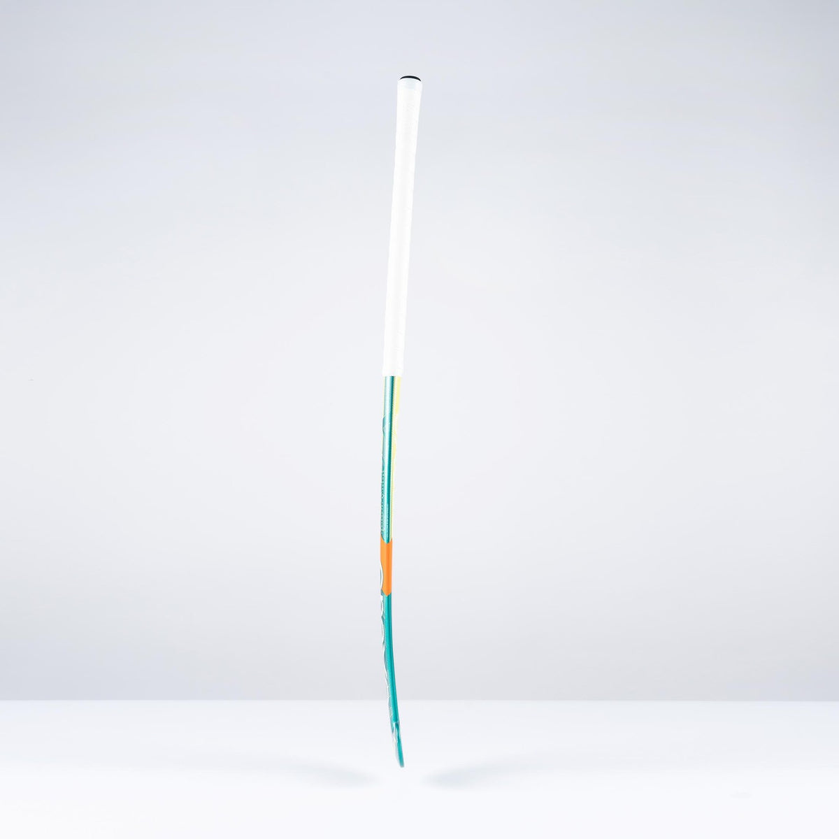 The Grays DB1Xi Dynabow Indoor Senior Hockey Stick 2026 stands upright against a plain white background, its sleek form and design by Grays reminiscent of an artist’s brush dipped in blue and orange.