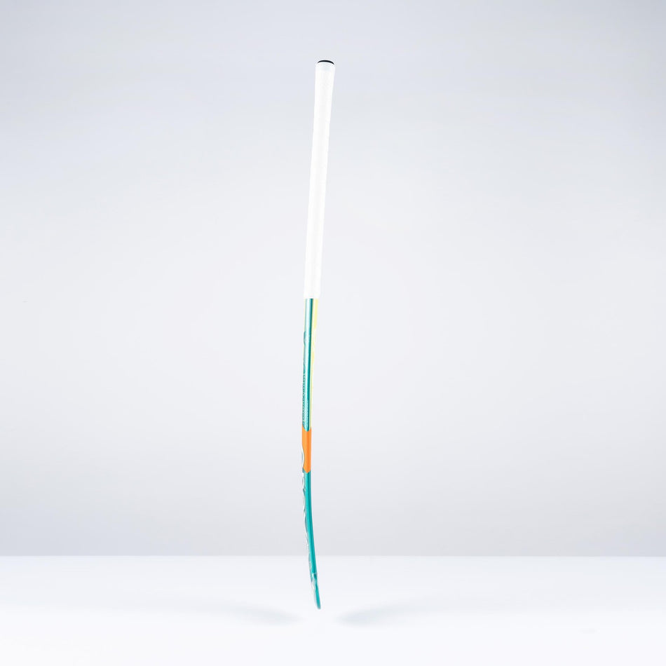 The Grays DB1Xi Dynabow Indoor Senior Hockey Stick 2026 stands upright against a plain white background, its sleek form and design by Grays reminiscent of an artist’s brush dipped in blue and orange.