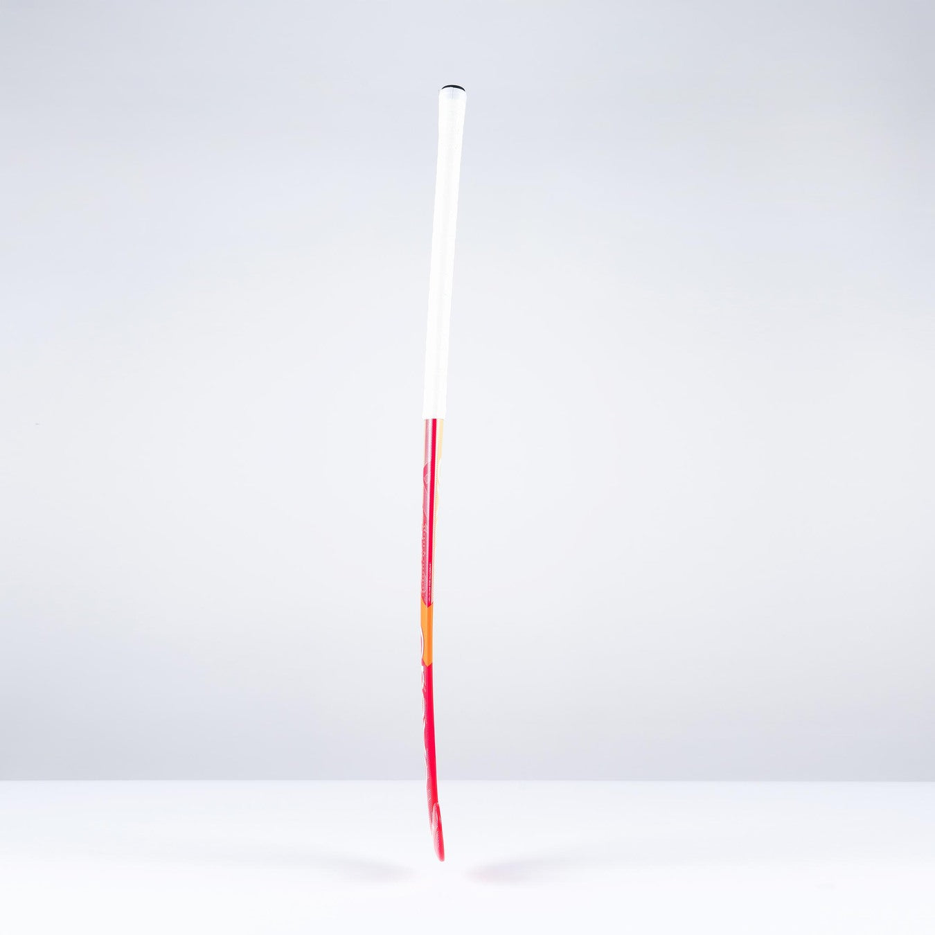 A single unlit firework rocket with a long red stick and a white cylindrical body stands upright against a plain, light gray background, evoking the sleek profile of the Grays GT0Xi Ultrabow Indoor Junior Hockey Stick 2026 by Grays.