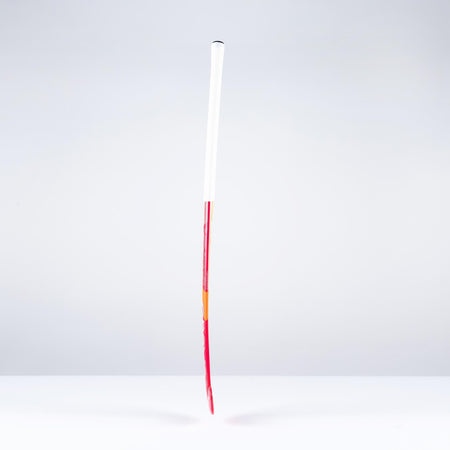 A single unlit firework rocket with a long red stick and a white cylindrical body stands upright against a plain, light gray background, evoking the sleek profile of the Grays GT0Xi Ultrabow Indoor Junior Hockey Stick 2026 by Grays.