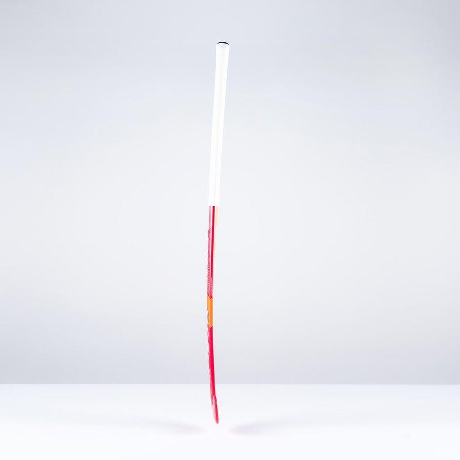 A single unlit firework rocket with a long red stick and a white cylindrical body stands upright against a plain, light gray background, evoking the sleek profile of the Grays GT0Xi Ultrabow Indoor Junior Hockey Stick 2026 by Grays.