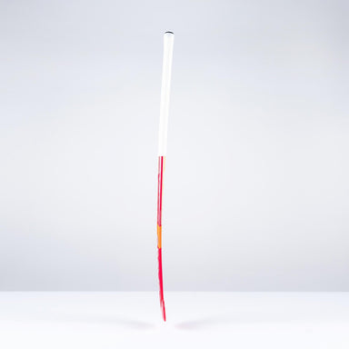 A single unlit firework rocket with a long red stick and a white cylindrical body stands upright against a plain, light gray background, evoking the sleek profile of the Grays GT0Xi Ultrabow Indoor Junior Hockey Stick 2026 by Grays.