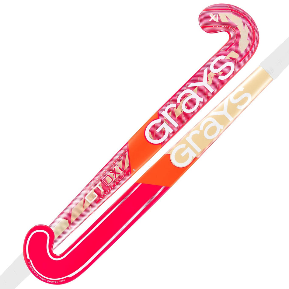 The Grays GT0Xi Ultrabow Indoor Junior Hockey Stick 2026 features bold pink, red, and gold colors, is perfect for developing core skills in indoor hockey, and displays the Grays logo prominently along the GT blade profile shaft.