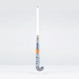 The Grays JB6GXi Jumbow Indoor Senior Hockey Stick stands upright against a plain light background, displaying its white handle and orange-blue shaft with bold GRAYS branding, designed for effective drag flicking.
