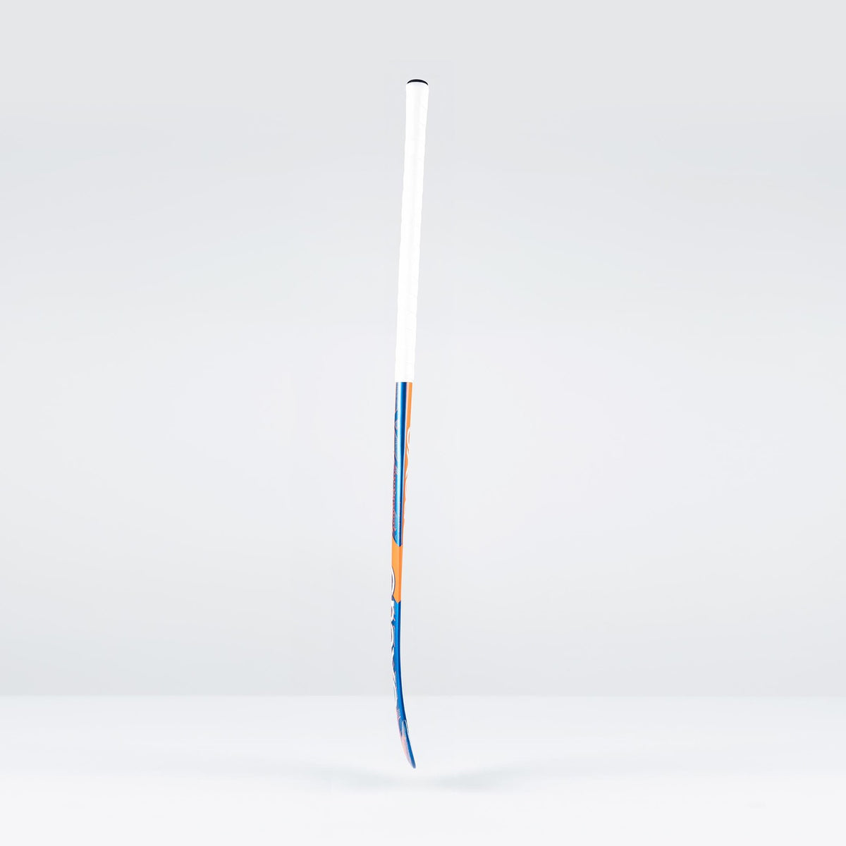 A Grays JB6GXi Jumbow Indoor Senior Hockey Stick with a white grip and blue-orange shaft detailing stands upright against a light gray background, showcasing the bold design signature of Grays.