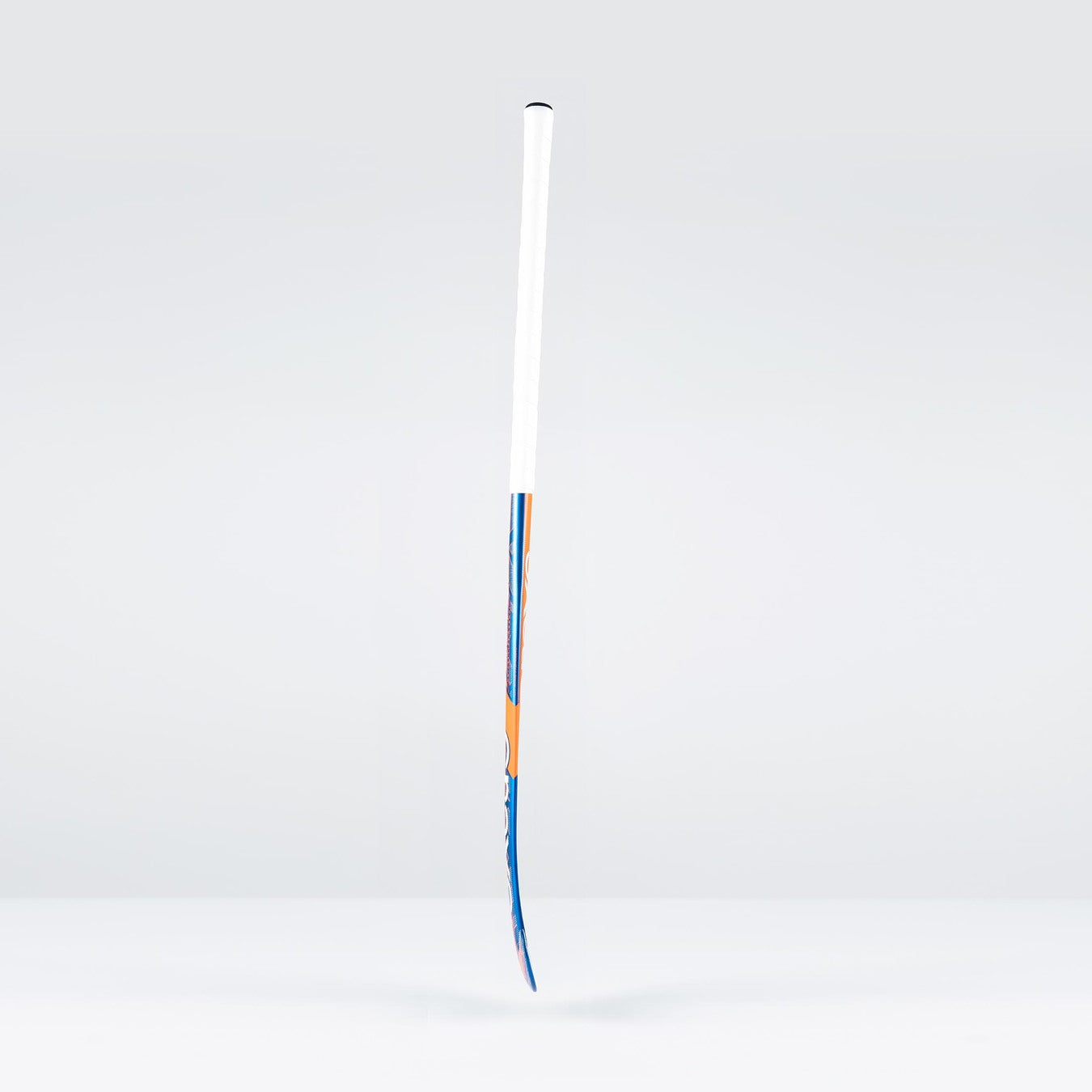 A Grays JB6GXi Jumbow Indoor Senior Hockey Stick with a white grip and blue-orange shaft detailing stands upright against a light gray background, showcasing the bold design signature of Grays.