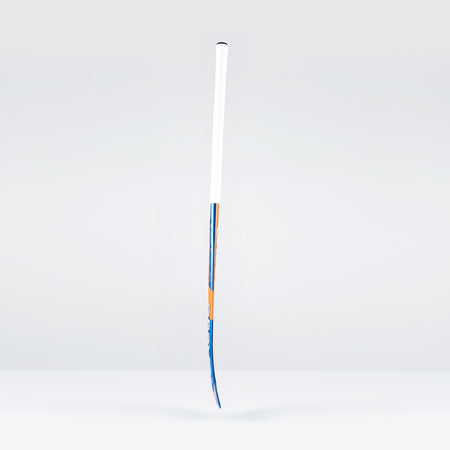 A Grays JB6GXi Jumbow Indoor Senior Hockey Stick with a white grip and blue-orange shaft detailing stands upright against a light gray background, showcasing the bold design signature of Grays.