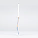 A Grays JB6GXi Jumbow Indoor Senior Hockey Stick with a white grip and blue-orange shaft detailing stands upright against a light gray background, showcasing the bold design signature of Grays.