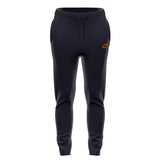 The Grays GTS Women's Training Trousers are black slim-fit joggers with an elastic waistband, drawstring, and small orange geometric logo on the left thigh. These Grays pants feature side pockets and are shown against a white background.