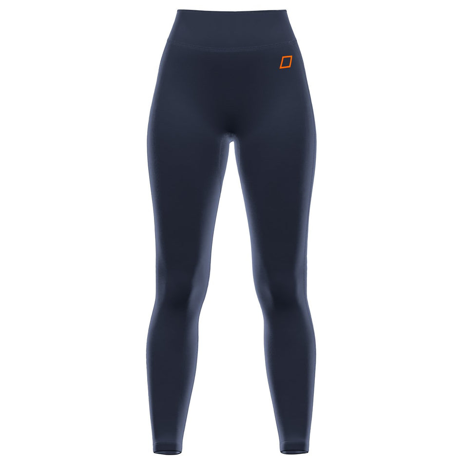 The Grays GTS Womens Hockey Leggings by Grays are dark navy high-waisted leggings with a fitted silhouette and a small orange rectangular logo on the left hip, inspired by performance sportswear and shown against a plain white background.