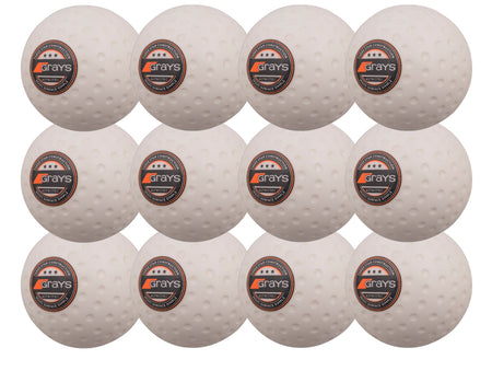 The Grays Astrotec 12 Ball Pack by Grays features twelve white dimpled hockey balls with orange-black logos, arranged in a 4x3 grid on a white background, ideal for synthetic pitches.