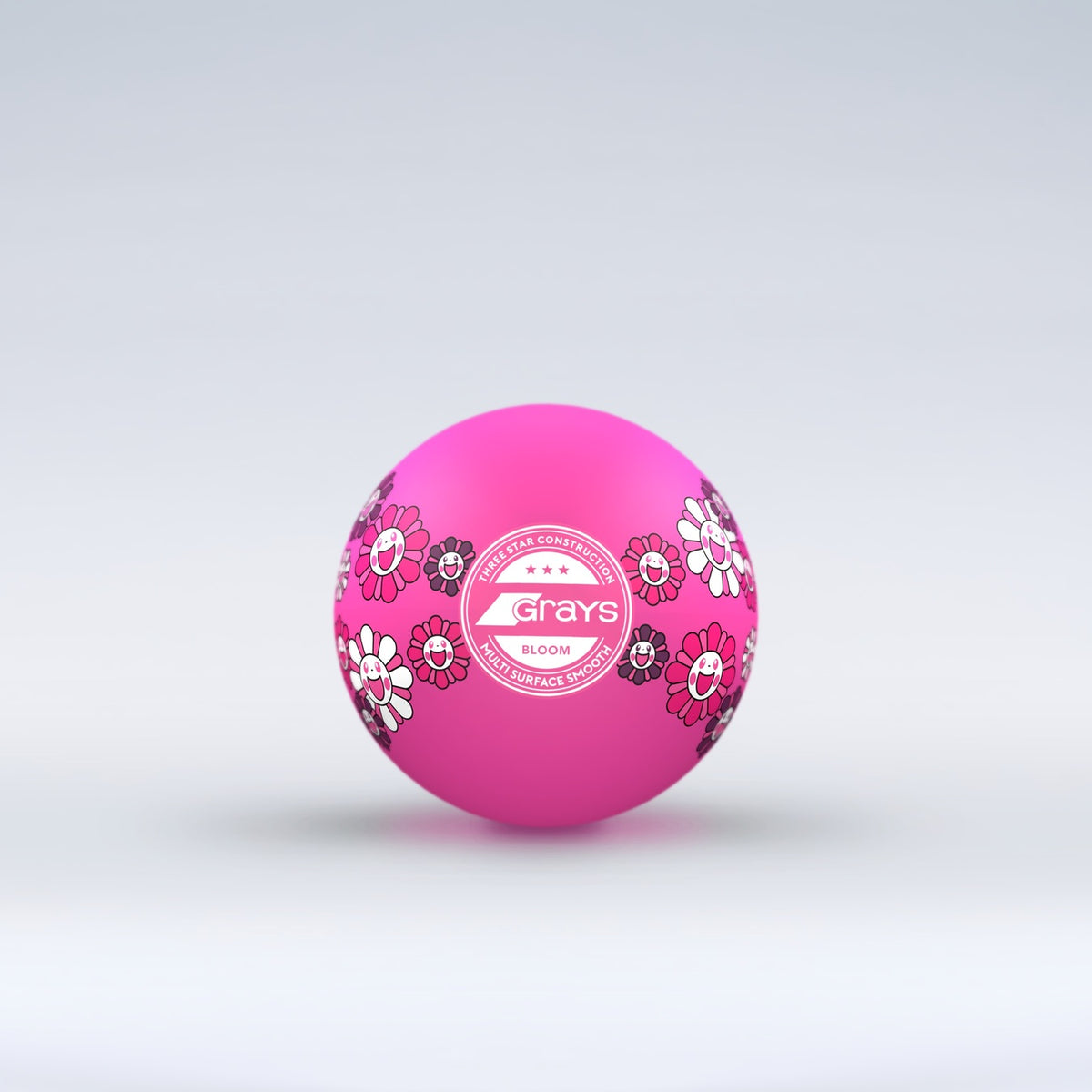 The Grays Novelty Hockey Ball 2026 features pink coloring with floral patterns, a central white Grays logo, and 3 star construction—perfect for hockey players. The ball sits against a light gray gradient background.